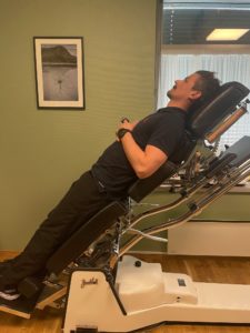 a man laying on a tilt table testing for pots