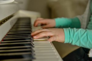 alt="A person playing piano